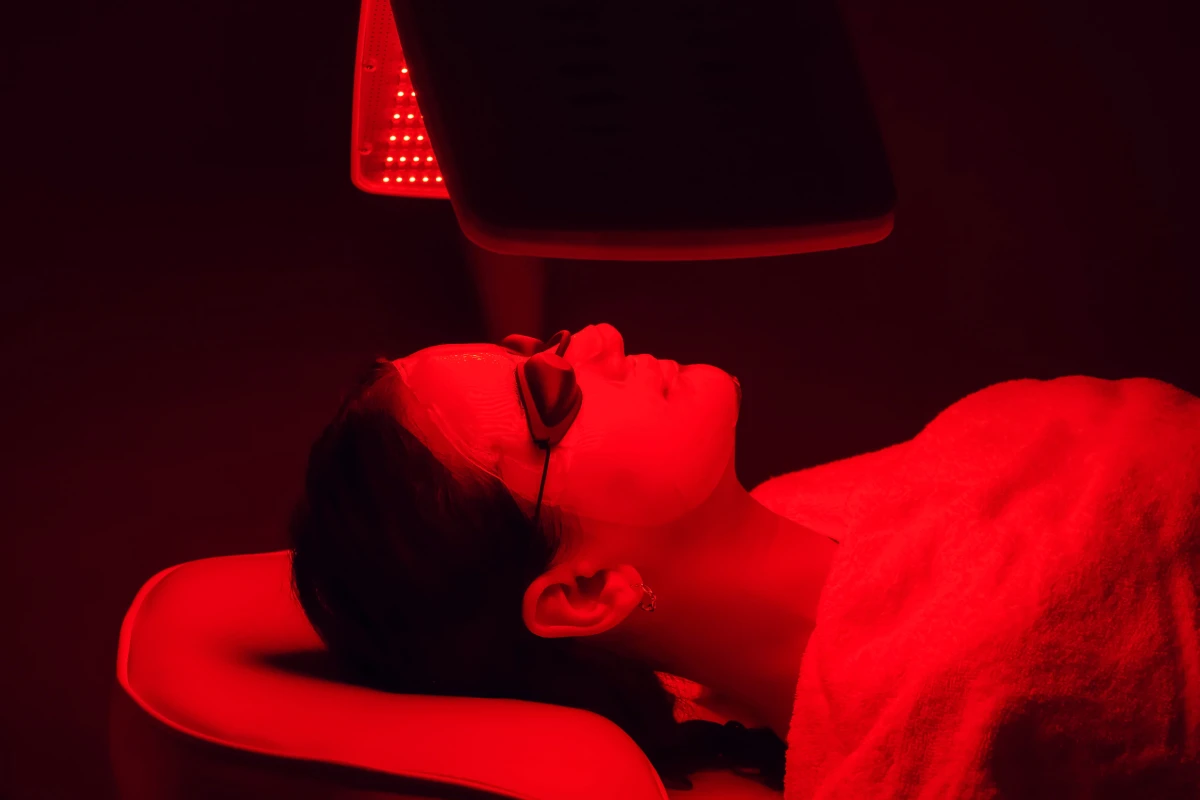 Woman relaxing during LED light therapy facial session in Cleveland, OH