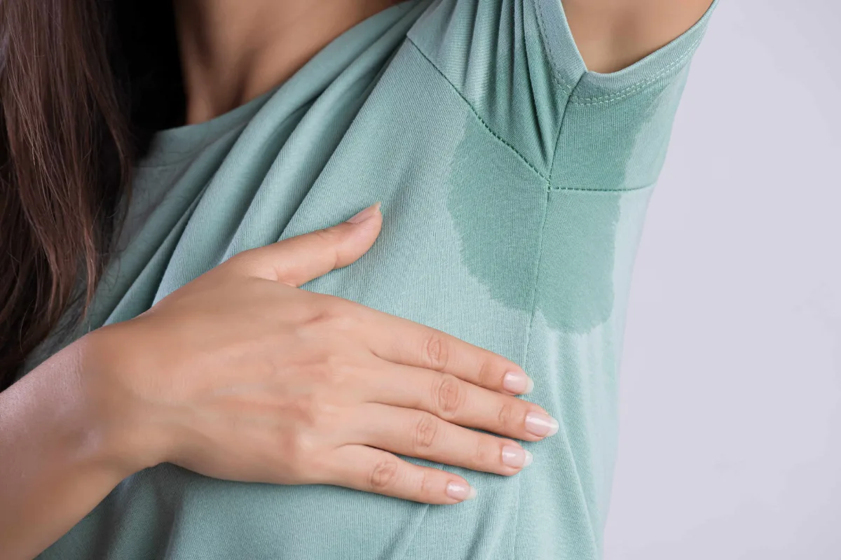 Woman showing visible underarm sweat and seeking underarm sweat control in Cleveland, OH
